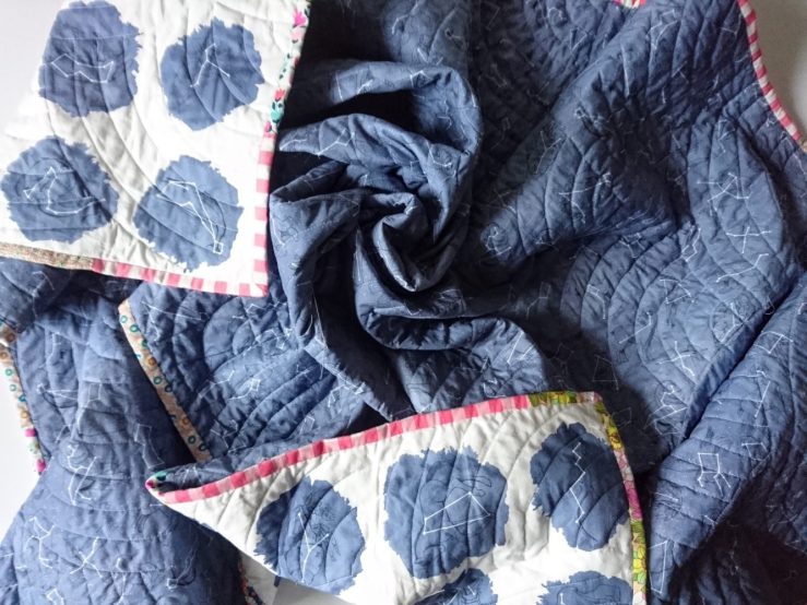 Wholecloth quilt with scrappy binding and night sky fabric